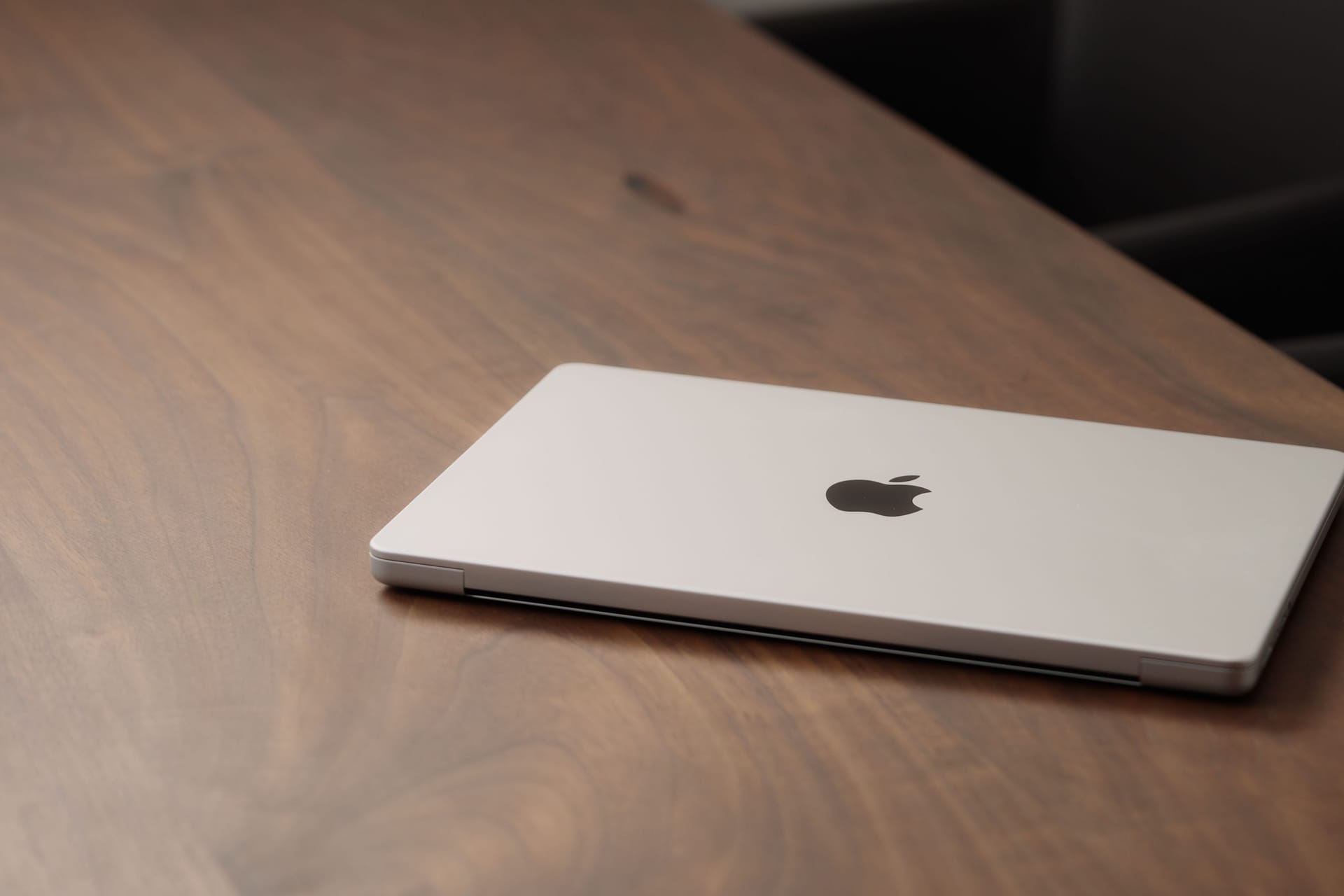 Saint-Petersburg, Russia - Circa December, 2022: CLoseup of the Macbook on walnut wood table with
